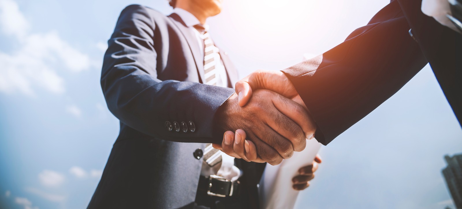 Business professionals shaking hands in corporate partnership